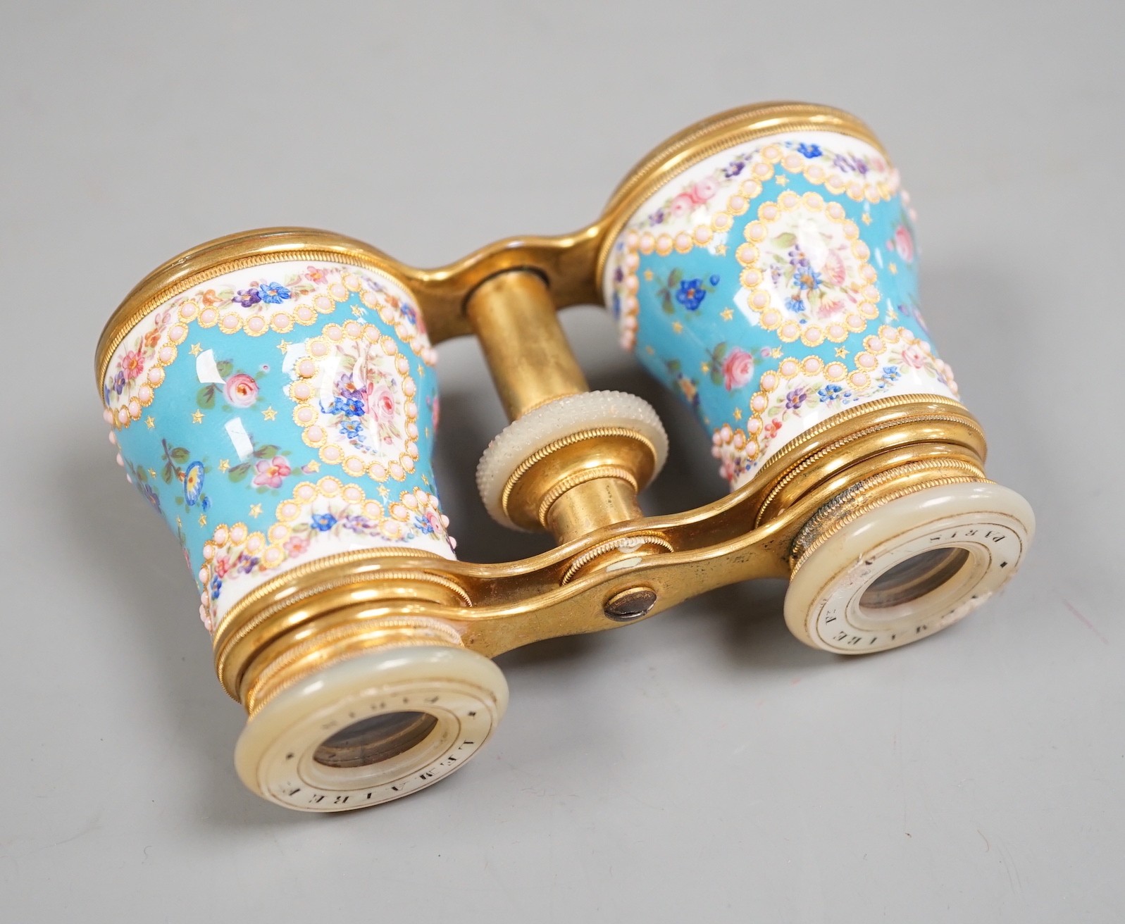 A pair of French enamel, brass and mother of pearl opera glasses, signed ‘Le Maire Paris’, in original fitted case